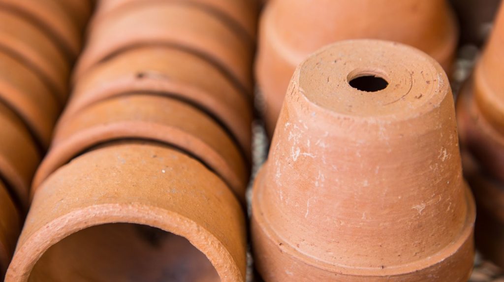 Macetas de barro con orificio de drenaje para girasoles Macetas de terracota apiladas mostrando el orificio de drenaje en la base
